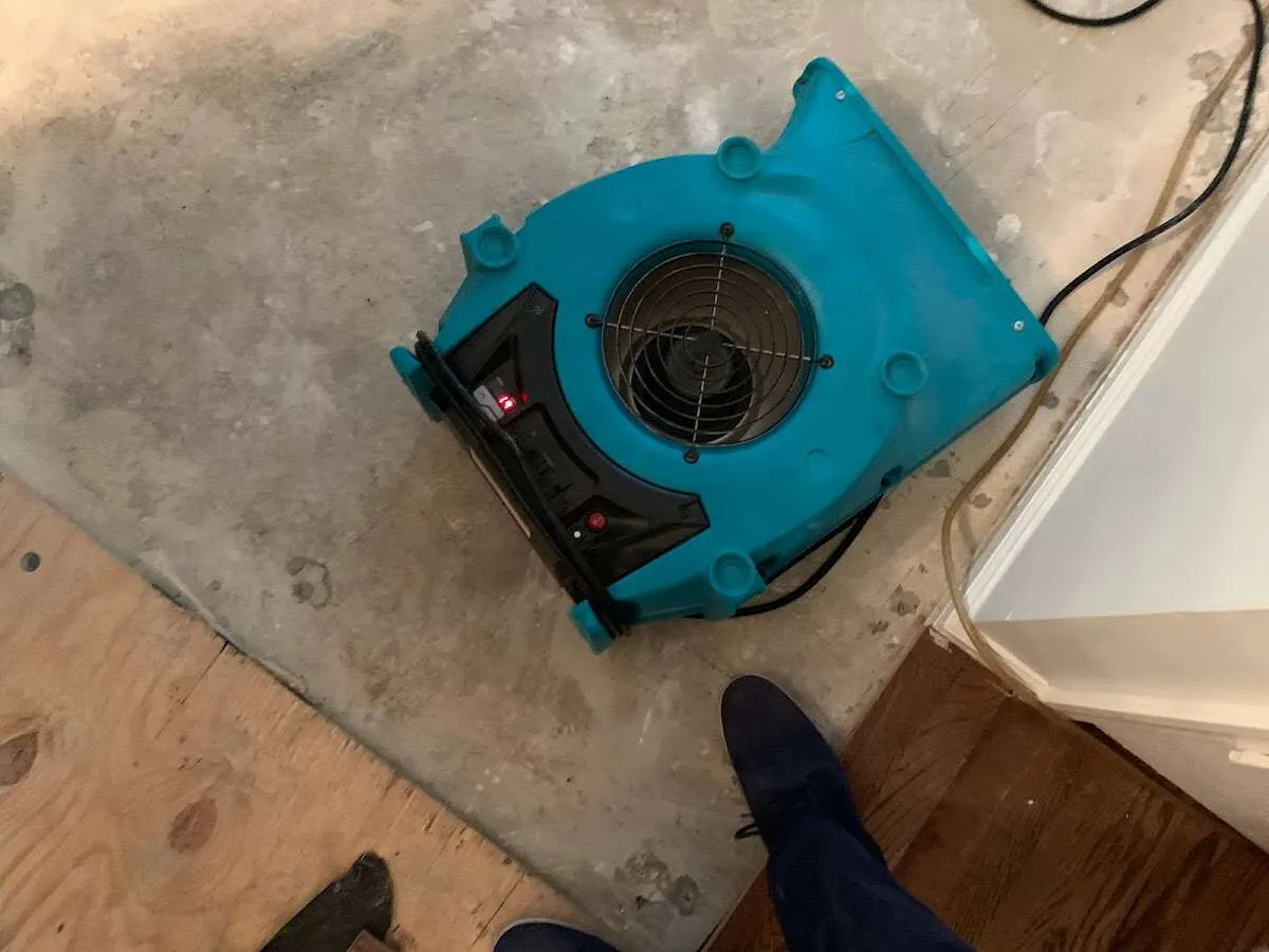 Air mover drying subfloor during Commercial Water Damage Restoration in Waterboro
